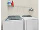 Practical laundry room featuring a washer, dryer, and shelving for storage at 4 Scottish Ln, Durham, NC 27707
