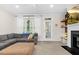 Bright and airy living room with a fireplace, shelves, and comfortable gray sectional sofa at 4 Scottish Ln, Durham, NC 27707