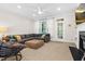 Comfortable living room with a large window, fireplace, and gray sectional sofa at 4 Scottish Ln, Durham, NC 27707