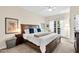 Spacious main bedroom with a ceiling fan, a large window, and a luxurious bed at 4 Scottish Ln, Durham, NC 27707