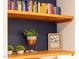 Display shelves with books, plants, and decorative items adding personality to the living space at 4 Scottish Ln, Durham, NC 27707