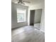 Bright bedroom with a large window and sliding mirror closet doors at 411 Gooseneck Drive # B6, Cary, NC 27513