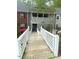 Exterior of condo featuring a latticework balcony and a white picket fence at 411 Gooseneck Drive # B6, Cary, NC 27513