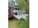 Exterior view of condo with latticework balcony, white picket fence, and lush landscaping at 411 Gooseneck Drive # B6, Cary, NC 27513