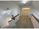Bright hallway showcasing a staircase, modern lighting, and access to additional rooms at 411 Gooseneck Drive # B6, Cary, NC 27513