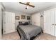 Bedroom with gray and white color scheme, featuring two closets and modern artwork at 4217 Pike Rd, Raleigh, NC 27613