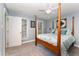Cozy bedroom featuring a four-poster bed, two large windows, and a ceiling fan at 4217 Pike Rd, Raleigh, NC 27613