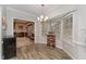 Bright breakfast nook with large bay window, wood-look floors, and chandelier, creating a cozy dining space at 4217 Pike Rd, Raleigh, NC 27613