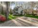 Charming two-story home featuring dormer windows, black shutters, and lush green lawn, providing great curb appeal at 4217 Pike Rd, Raleigh, NC 27613