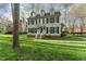 Charming two-story home with black shutters and a manicured lawn offering classic elegance and inviting curb appeal at 4217 Pike Rd, Raleigh, NC 27613