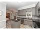 Modern kitchen features gray cabinetry, granite countertops, stainless steel appliances, and an island, perfect for cooking at 4217 Pike Rd, Raleigh, NC 27613