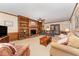 Spacious living room features a brick fireplace, built-in bookshelves, and comfortable seating, perfect for relaxation at 4217 Pike Rd, Raleigh, NC 27613