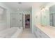 Bright and airy main bathroom showcasing double vanity, large tub, and glass shower at 4217 Pike Rd, Raleigh, NC 27613