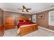 Comfortable bedroom featuring wood furniture, neutral carpet and ceiling fan at 4217 Pike Rd, Raleigh, NC 27613