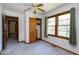 Light-filled bedroom with closet, neutral carpet, and windows framed by green curtains at 4308 James Rd, Raleigh, NC 27616