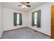 A carpeted bedroom with two windows and a ceiling fan at 4308 James Rd, Raleigh, NC 27616