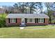 Charming brick home with a well-maintained lawn and traditional black shutters enhancing its curb appeal at 4308 James Rd, Raleigh, NC 27616