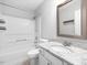 A full bathroom featuring a shower over the tub, granite countertop, chrome faucet and vanity storage at 5 Maidenhair Ct, Durham, NC 27703