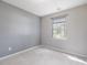 Bedroom with carpeted floors, neutral wall paint, and a window bringing in natural light at 5 Maidenhair Ct, Durham, NC 27703