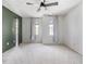 Spacious carpeted bedroom with a ceiling fan, neutral walls, and natural light streaming in through draped windows at 5 Maidenhair Ct, Durham, NC 27703