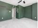 A stylish bedroom with a ceiling fan, plush carpet and olive green walls, creating a calm and inviting space at 5 Maidenhair Ct, Durham, NC 27703