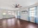 Bright living room with hardwood floors, ceiling fan, and large windows providing ample natural light and backyard views at 5 Maidenhair Ct, Durham, NC 27703