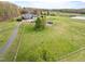 Sprawling property with large front lawn, mature trees, and circular driveway leading to the garage at 500 Walnut Hill Dr, Hillsborough, NC 27278