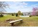 Spacious backyard including a fire pit, bench, and expansive lawns at 500 Walnut Hill Dr, Hillsborough, NC 27278