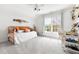 Bright bedroom featuring an orange daybed, a sunny window, and white walls at 500 Walnut Hill Dr, Hillsborough, NC 27278