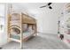 Bright bedroom featuring bunk beds, soft carpet, a ceiling fan, and built in bookshelves at 500 Walnut Hill Dr, Hillsborough, NC 27278