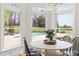 Bright breakfast nook with views of the pool and outdoor spaces at 500 Walnut Hill Dr, Hillsborough, NC 27278