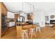 Kitchen island featuring seating and pendant lighting; stainless steel appliances and wooden cabinets at 500 Walnut Hill Dr, Hillsborough, NC 27278