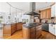 Kitchen featuring stainless steel appliances, wooden cabinets, black countertops, and a center island at 500 Walnut Hill Dr, Hillsborough, NC 27278