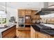 Kitchen featuring stainless steel appliances, wooden cabinets, and black countertops at 500 Walnut Hill Dr, Hillsborough, NC 27278