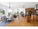 Open-concept kitchen and dining area with hardwood floors, views, and an island with seating at 500 Walnut Hill Dr, Hillsborough, NC 27278