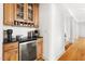 Kitchen featuring stainless steel appliances, wooden cabinets, black countertops, and a drink cooler at 500 Walnut Hill Dr, Hillsborough, NC 27278