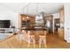 Kitchen island featuring seating and pendant lighting; stainless steel appliances and wooden cabinets at 500 Walnut Hill Dr, Hillsborough, NC 27278
