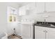 Functional laundry room equipped with modern washer, dryer, ample cabinetry, and sink at 500 Walnut Hill Dr, Hillsborough, NC 27278