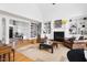 Bright living room featuring a fireplace, built-in bookshelves, and hardwood floors at 500 Walnut Hill Dr, Hillsborough, NC 27278