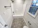 Bathroom with all white shower, tile floors, toilet, sink, and window at 5005 Baywood Forest Dr, Knightdale, NC 27545