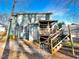 Backyard view of home featuring a raised deck, mature trees, and landscaping at 5005 Baywood Forest Dr, Knightdale, NC 27545