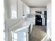 Bright kitchen features all white cabinets, countertops, backsplash, and modern appliances at 5005 Baywood Forest Dr, Knightdale, NC 27545