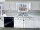 Charming kitchen with white cabinets, black appliances, and window view at 5005 Baywood Forest Dr, Knightdale, NC 27545