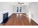 Open living room with hardwood floors, fireplace, and access to an outdoor area at 5005 Baywood Forest Dr, Knightdale, NC 27545