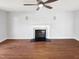 Spacious living room features hardwood floors, a fireplace with white mantle, and a ceiling fan at 5005 Baywood Forest Dr, Knightdale, NC 27545