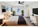 Inviting bedroom featuring a ceiling fan, large window, and stylish decor at 5005 Baywood Forest Dr, Knightdale, NC 27545