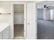 Open walk in closet leads to a bedroom with ceiling fan and light at 5005 Baywood Forest Dr, Knightdale, NC 27545
