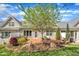 Backyard view shows brick patio with seating, greenery, and home exterior with large windows at 5033 Homeplace Dr, Apex, NC 27539