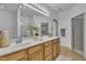 Bathroom with double sink vanity, large mirror, and shower and tub combo at 5033 Homeplace Dr, Apex, NC 27539