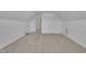 Bright bedroom features neutral carpet, white walls, closet doors, and an adjoining hallway at 5033 Homeplace Dr, Apex, NC 27539